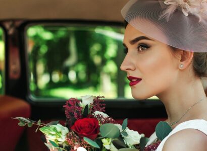 Beautiful bride sitting in a classic rental car.
